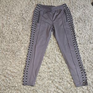 Gray Track Pants with Side Stripes with the word pink